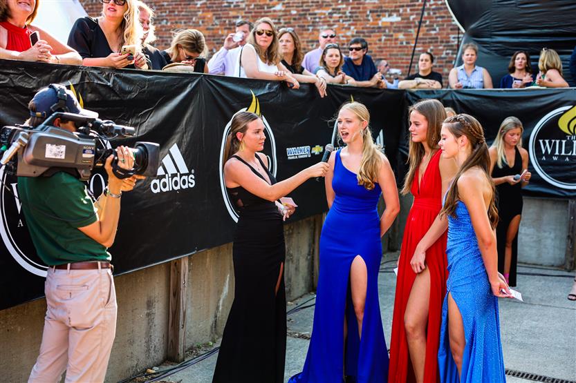 Students are interviewed on a red carpet